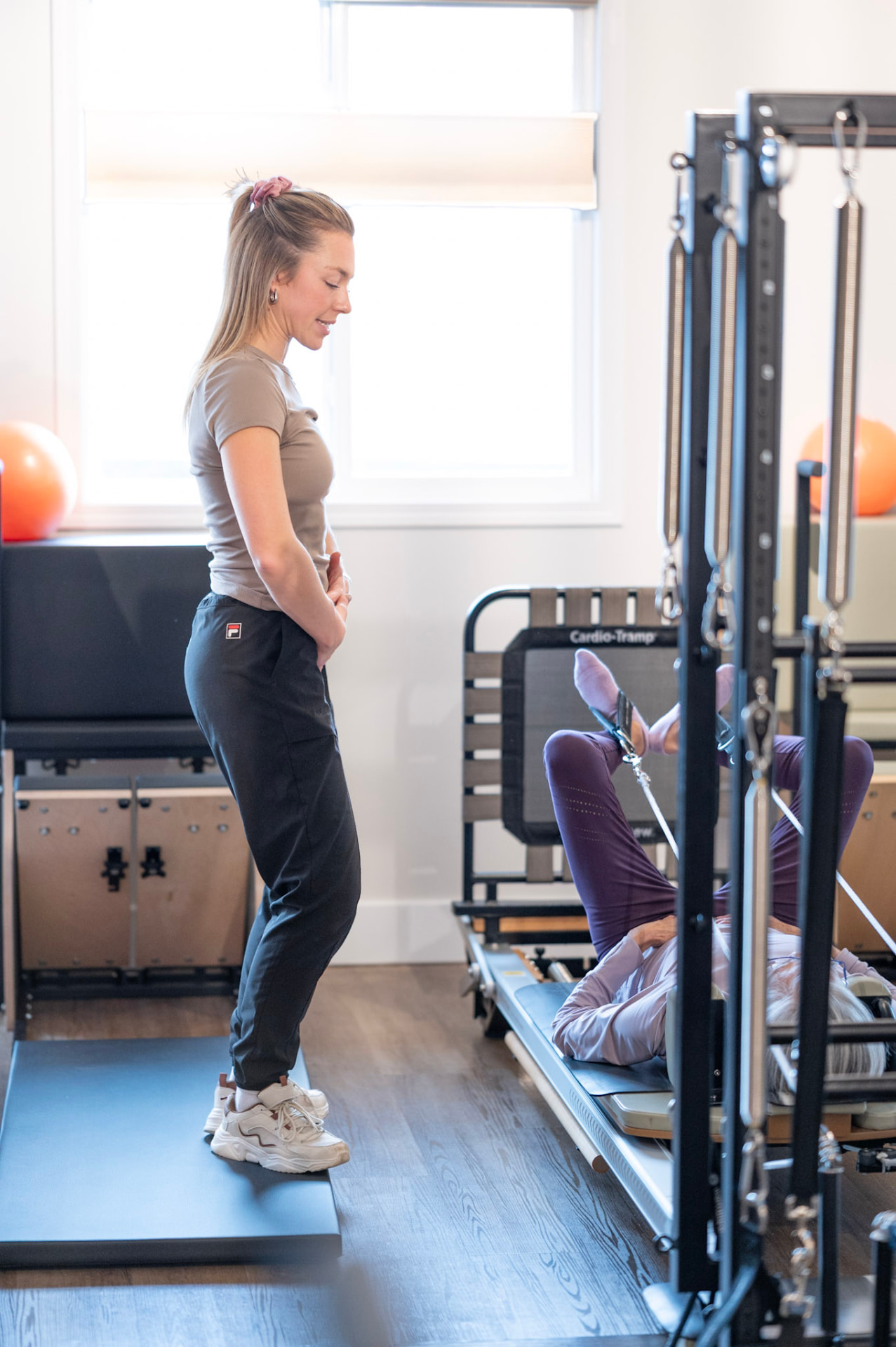 An instructor guiding a client on the Combo Unit
